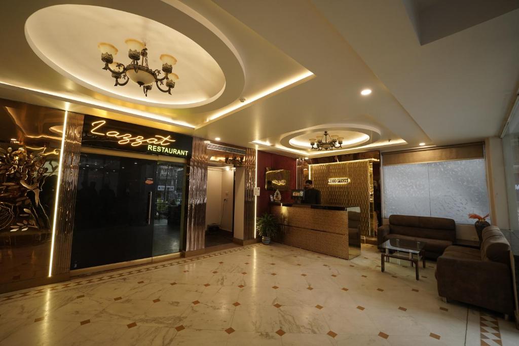 a lobby of a hotel with a couch and a table at Hotel Astor in Patna