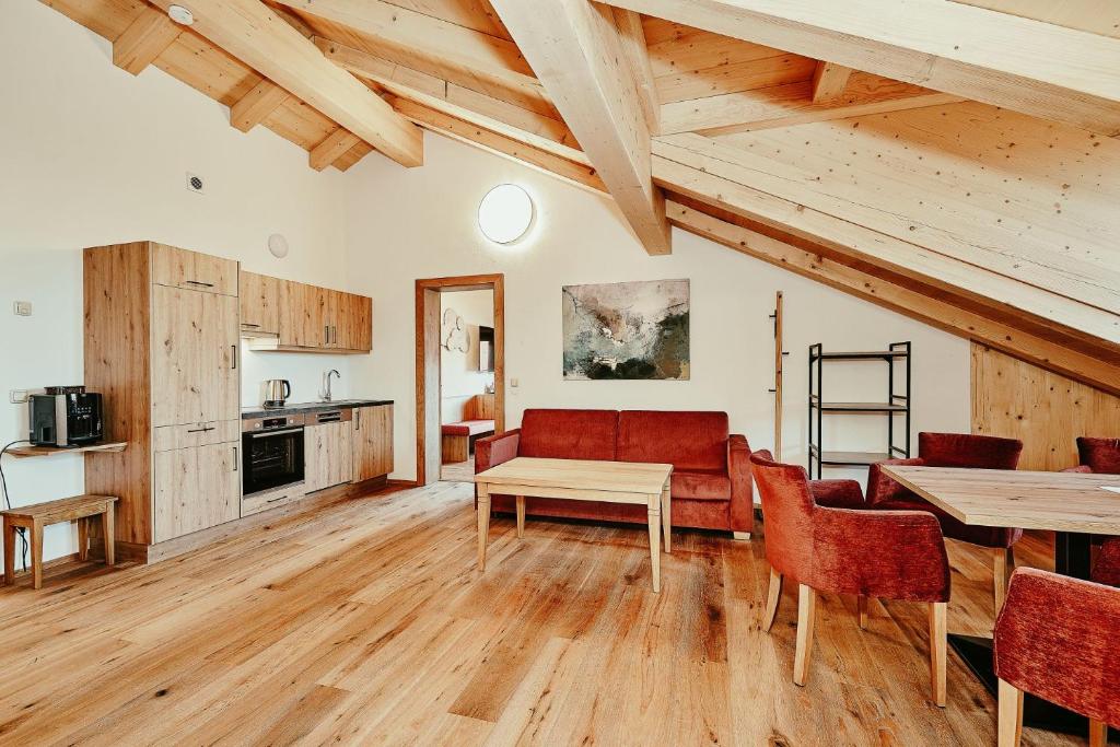 a kitchen and living room with a table and chairs at Landhotel Berger in Ainring