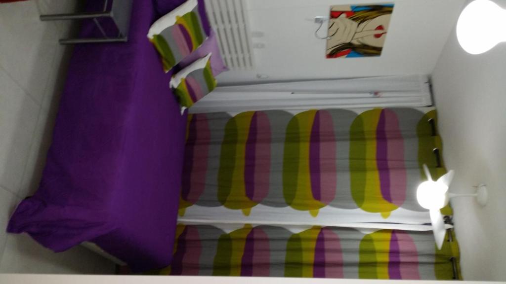 a room with a staircase with purple and yellow stripes at Flat Hilário in Rio de Janeiro