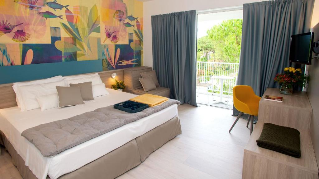a bedroom with a large bed in a room at Hotel President in Lignano Sabbiadoro