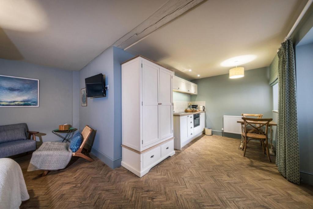 a room with a large white cabinet and a kitchen at The Globe Inn in Wells next the Sea