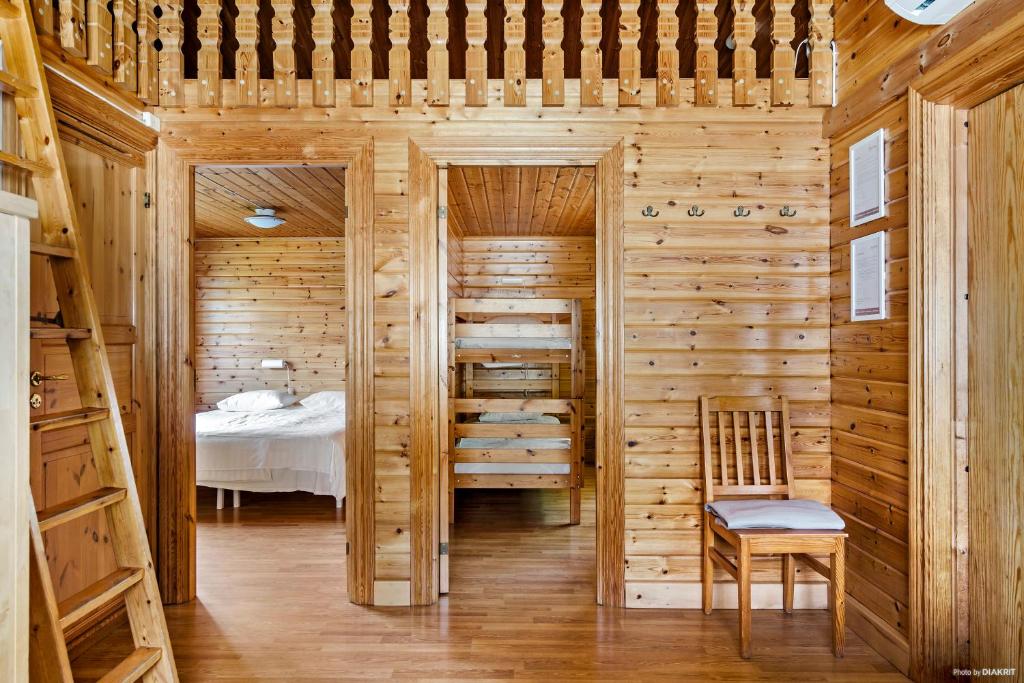 a bedroom with a bed and a wooden wall at First Camp Mölle-Höganäs in Mölle