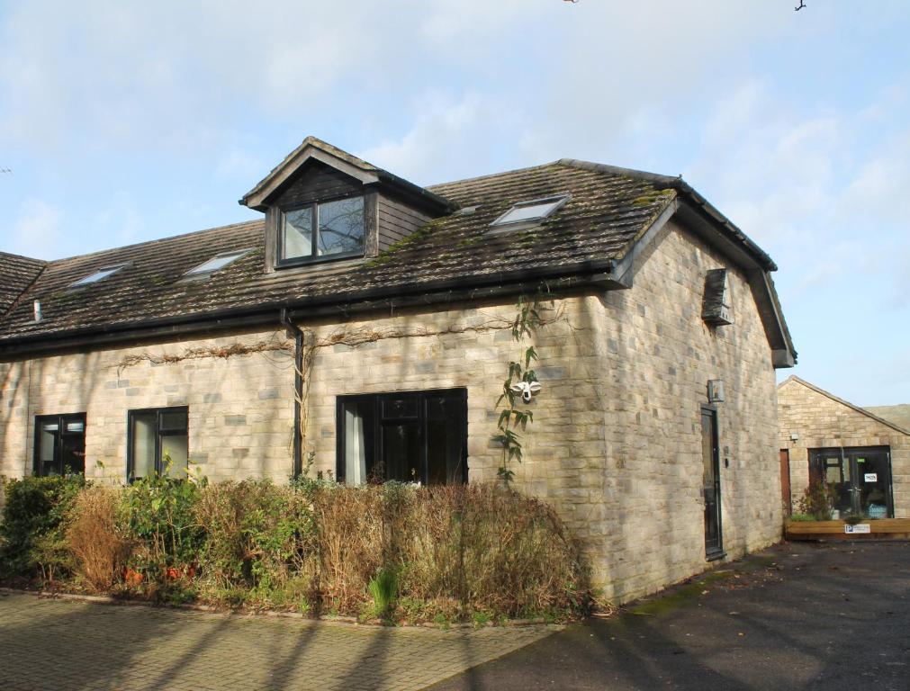 an old brick house with a roof at Castle View Annex in Wareham