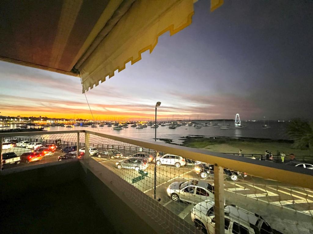 a view of a parking lot with a marina at sunset at El Remanso - Suite 104 in Punta del Este