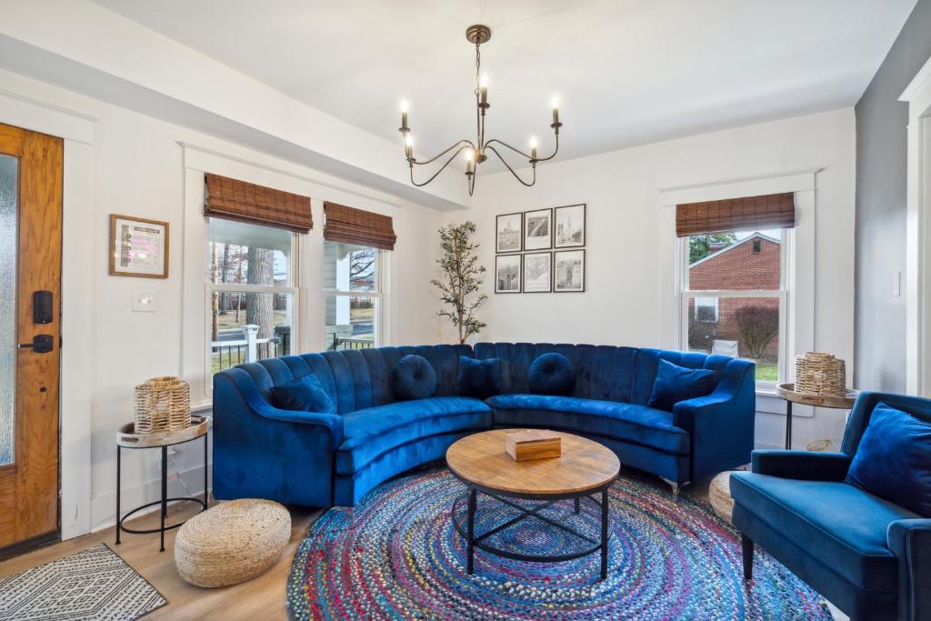 a living room with a blue couch and a table at Cottage on Main in Lansdale