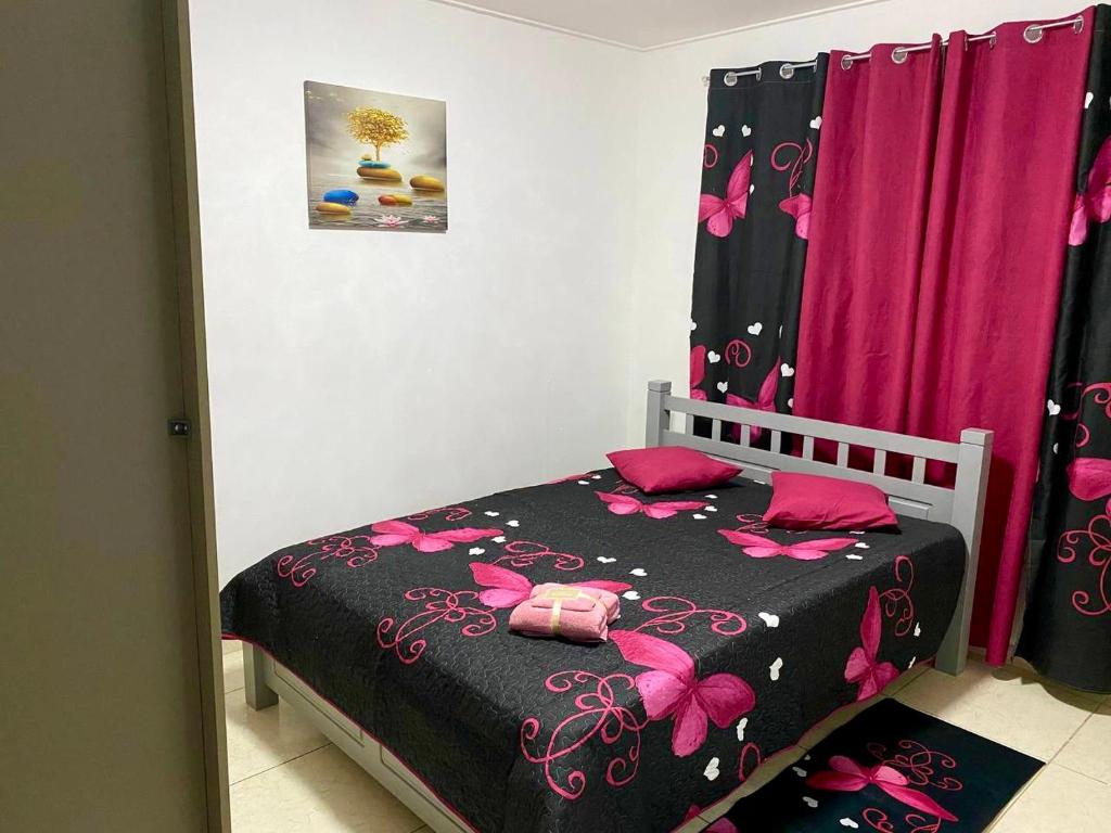 a bedroom with a bed with pink butterflies on it at AJ resort in Fontein