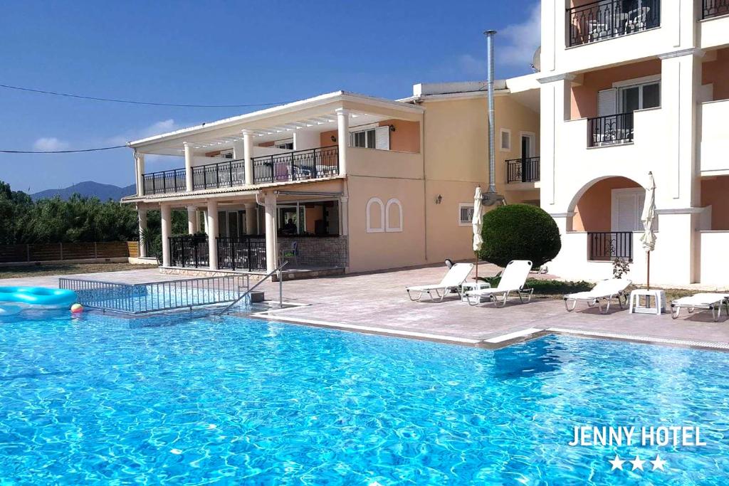 a large swimming pool in front of a building at Jenny Hotel in Laganas