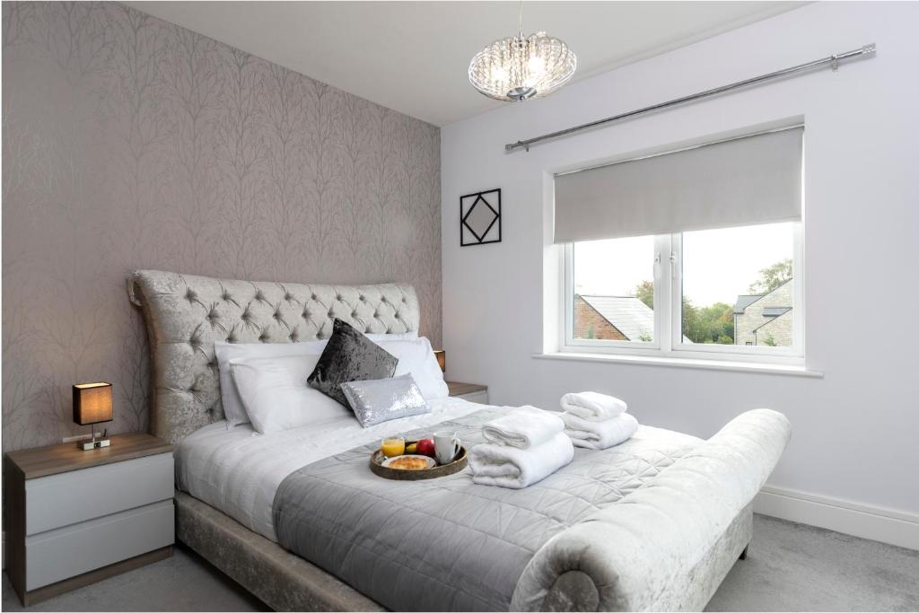 a bedroom with a bed with a bowl of fruit on it at 4 Bed 2 Bath Luxury Home in County Durham in Chilton