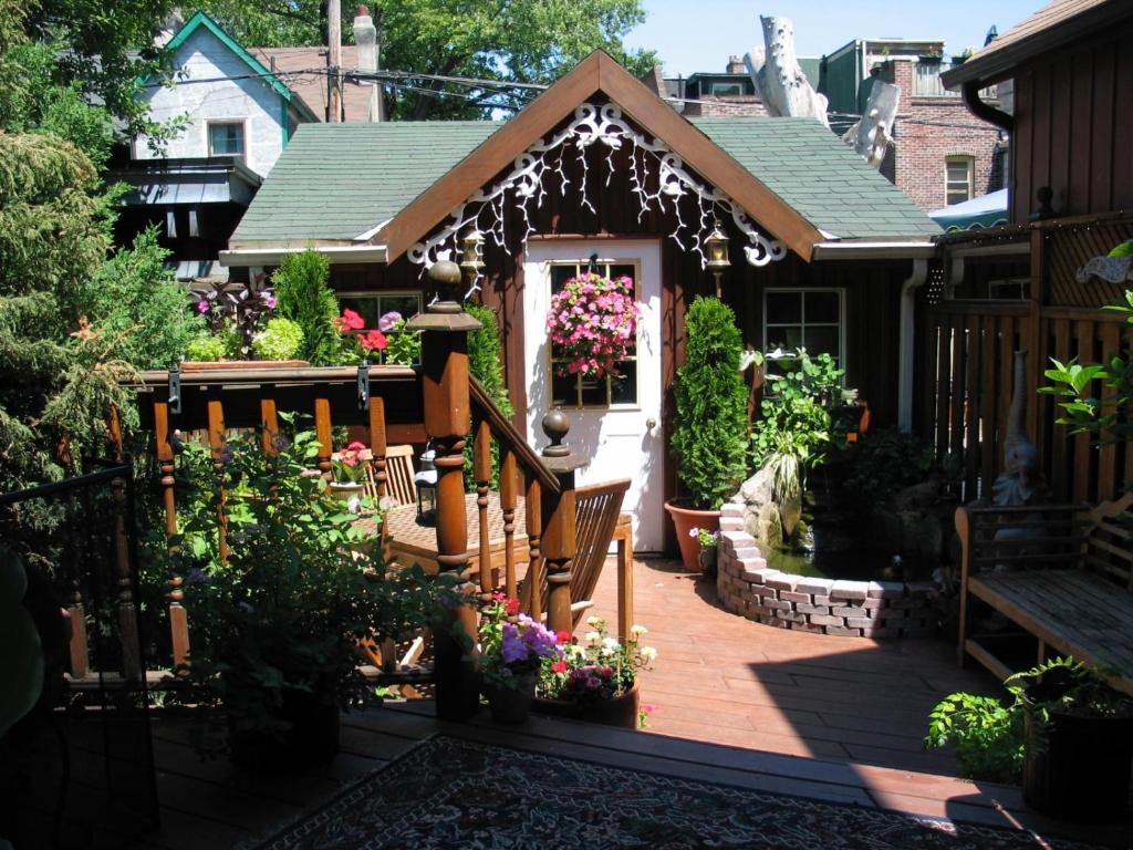 a small house with a deck with flowers at A Seaton Dream in Toronto