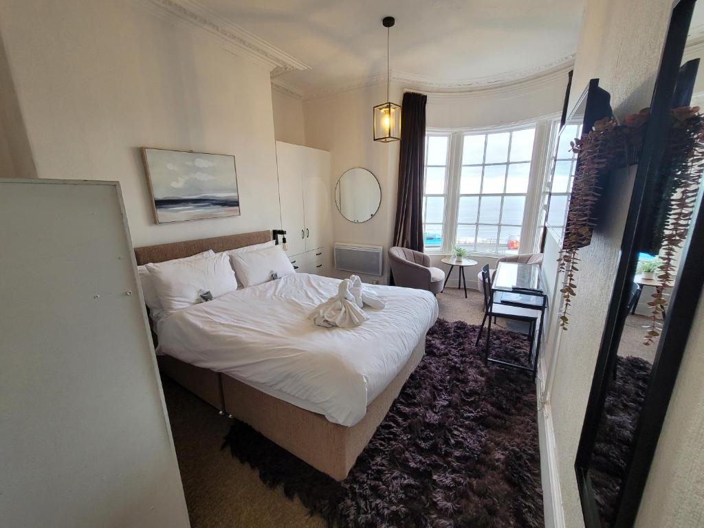 a hotel room with a bed and a window at Sea View flat 2 with Fast WiFi and FREE parking in Scarborough
