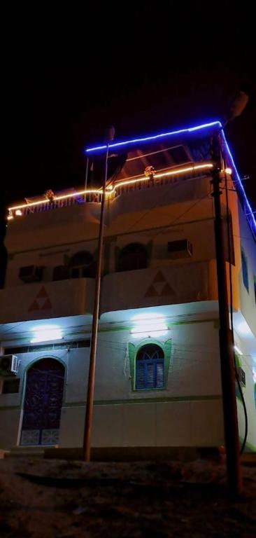 a white boat with blue lights on top of it at Gamal Robob Nubian Guest House in Aswan