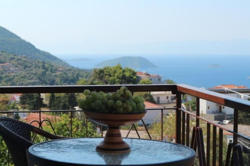 a bowl of fruit sitting on a table on a balcony at Demie and George Ηouse in Loutraki