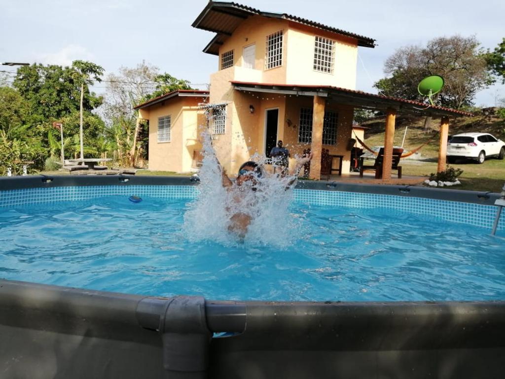 a person in a swimming pool in a house at La Cima del Cielo in Las Lajas