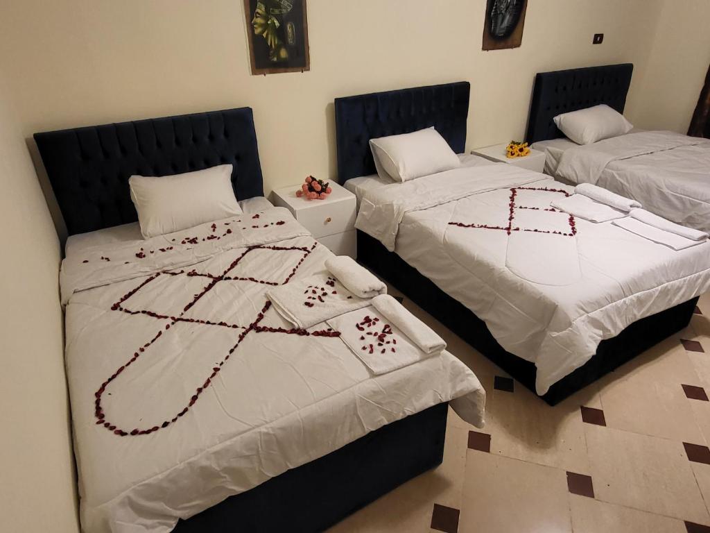 two beds sitting next to each other in a room at Lucky Pyramids View in Cairo
