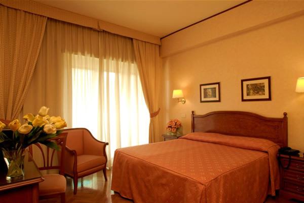 ローマにあるHotel San Pietroのベッドルーム1室(ベッド1台、花瓶1本付)