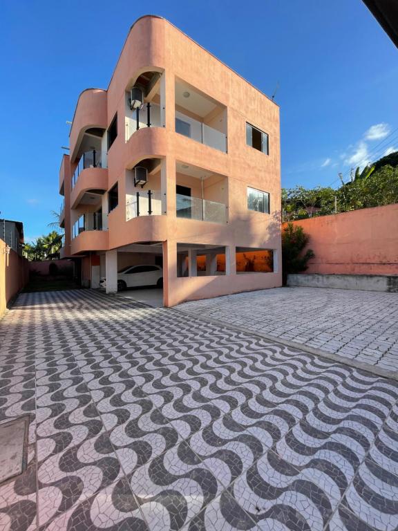 a building with a cobblestone street in front of it at Sol de Pirangi in Parnamirim