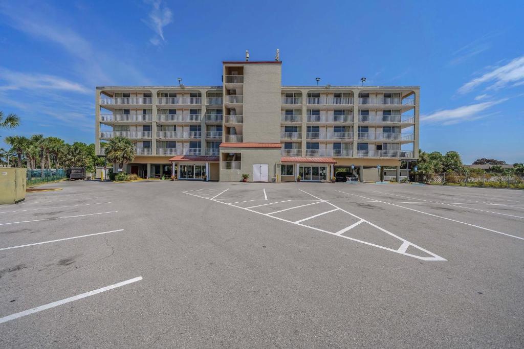 a parking lot in front of a large building at Baymont by Wyndham Panama City Beach in Panama City Beach