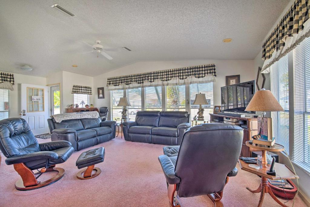 a living room with couches and chairs and windows at Lady Lake House with Lanai and Community Pool! in Lady Lake