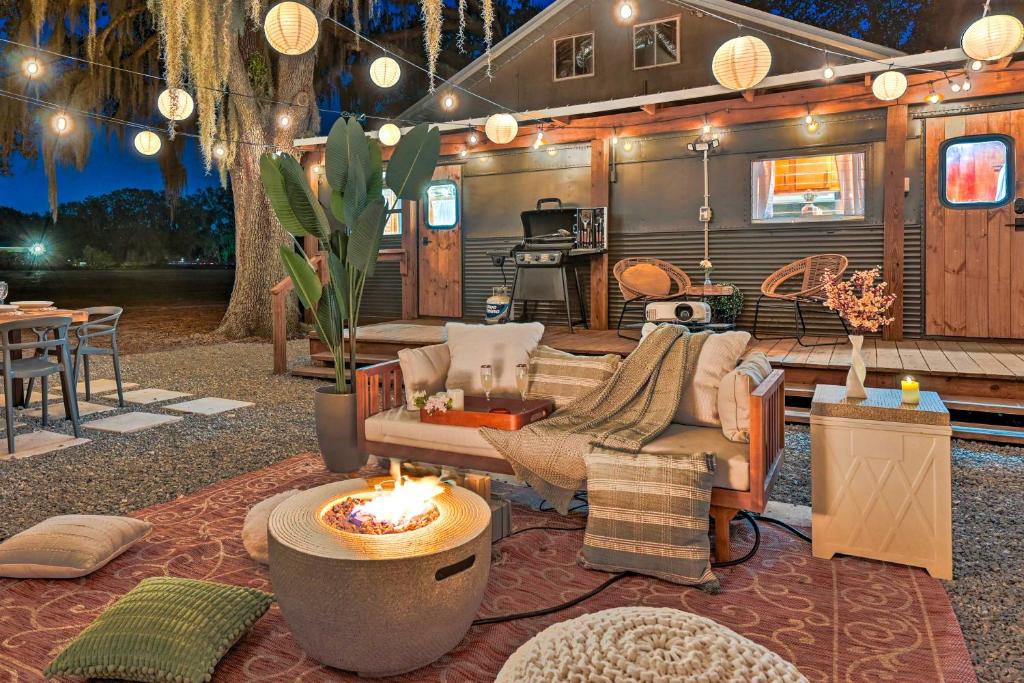 a living room with a couch and a fire place at Charming Tiny Home with Private Hot Tub! in Plant City