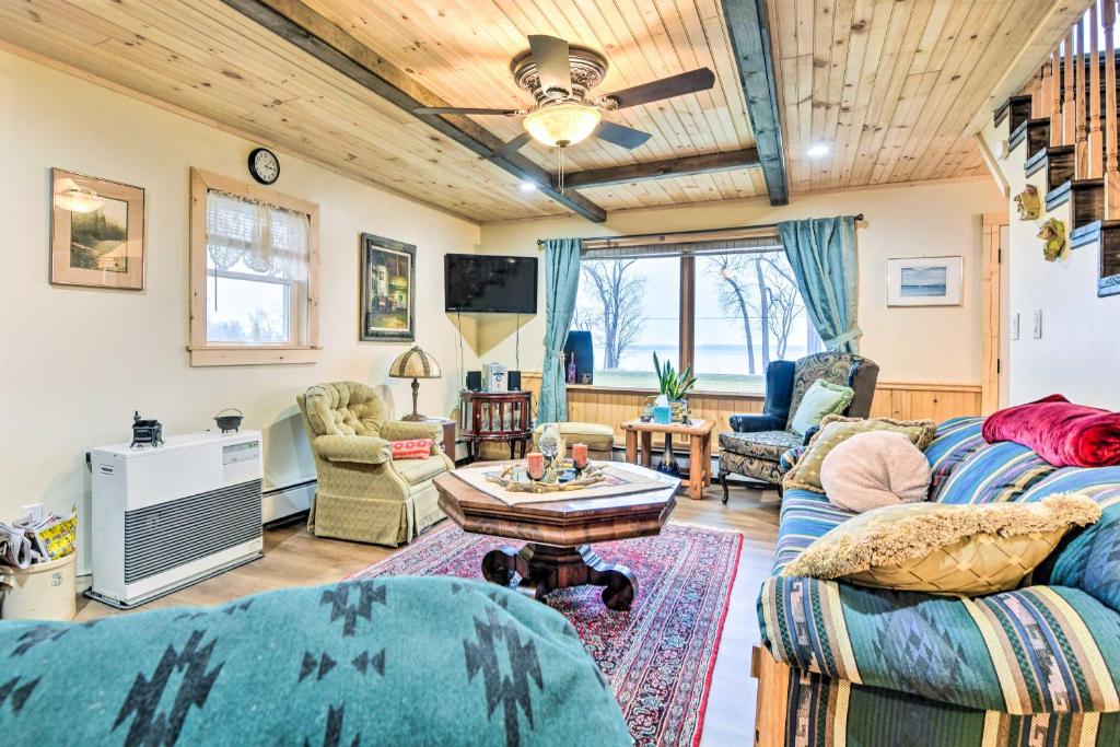 a living room with a couch and a table at Lake Champlain Vacation Rental on Private Lot in Chazy