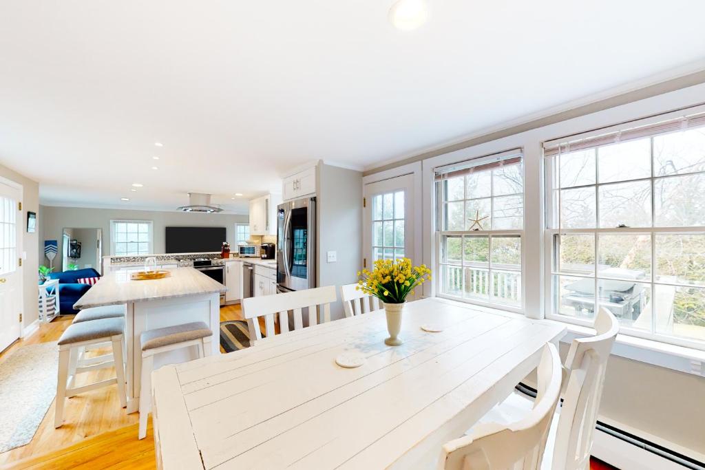 a kitchen and living room with a white table and chairs at Chatham Living in Chatham