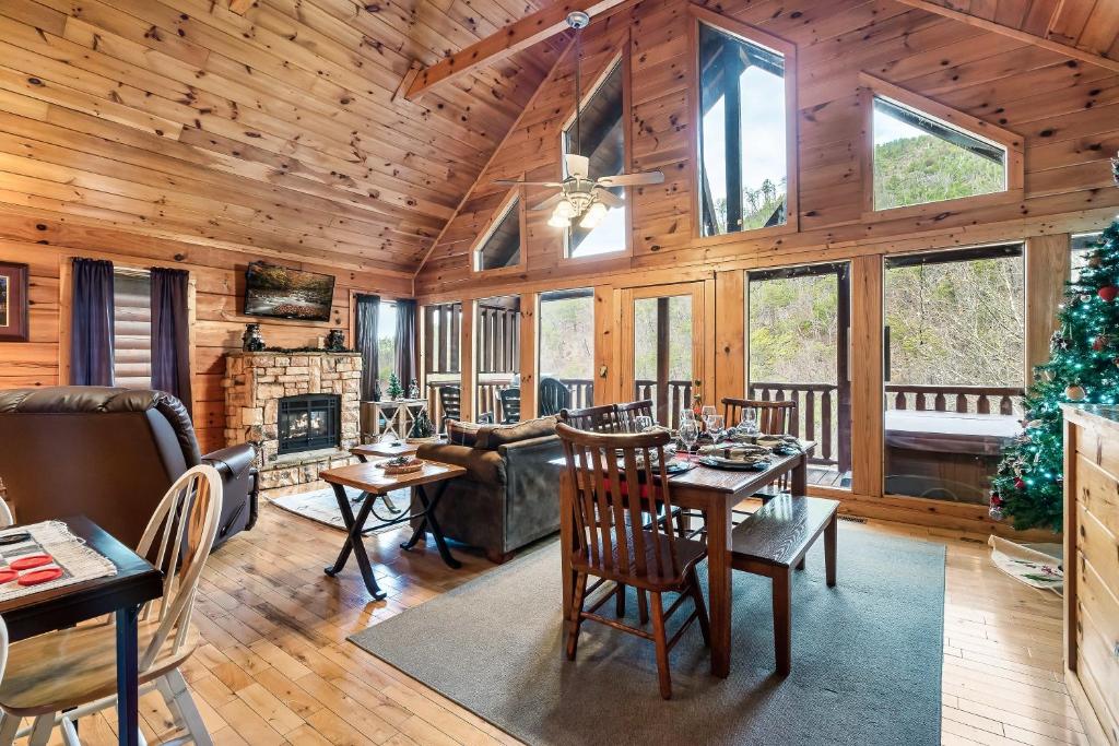 a living room with a christmas tree in a cabin at Cubby Bear Smoky Mountain Cabin - Summer Specials! in Sevierville