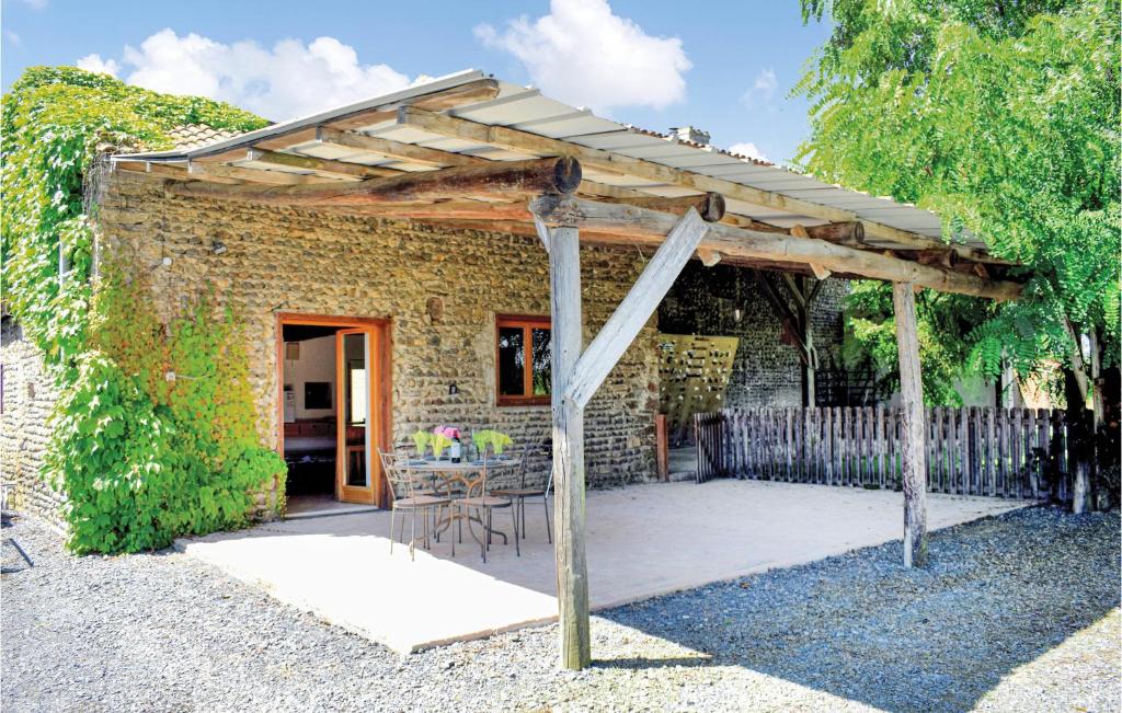 a wooden pergola with a table in front of a building at Beautiful Home In Tasque With Wifi, Private Swimming Pool And Outdoor Swimming Pool in Tasque