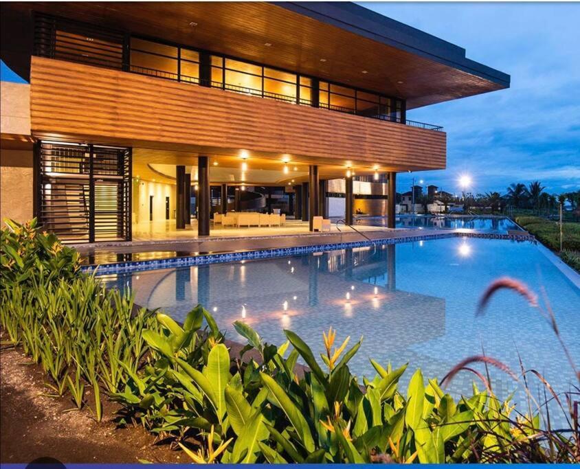 een groot zwembad voor een huis bij Seafront OnCall - private jacuzzi with 4 cozy bedrooms in San Juan