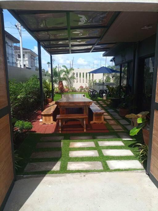 a patio with a table and benches in a building at Seafront OnCall - private jacuzzi with 4 cozy bedrooms in San Juan
