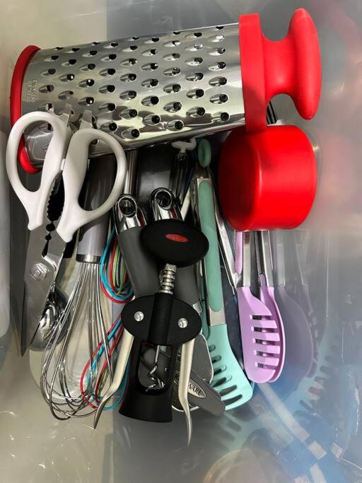 a bunch of kitchen utensils hanging from a rack at Seafront OnCall - private jacuzzi with 4 cozy bedrooms in San Juan