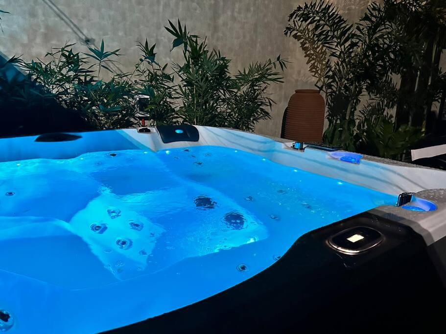 a jacuzzi tub with blue lights on it at Seafront OnCall - private jacuzzi with 4 cozy bedrooms in San Juan