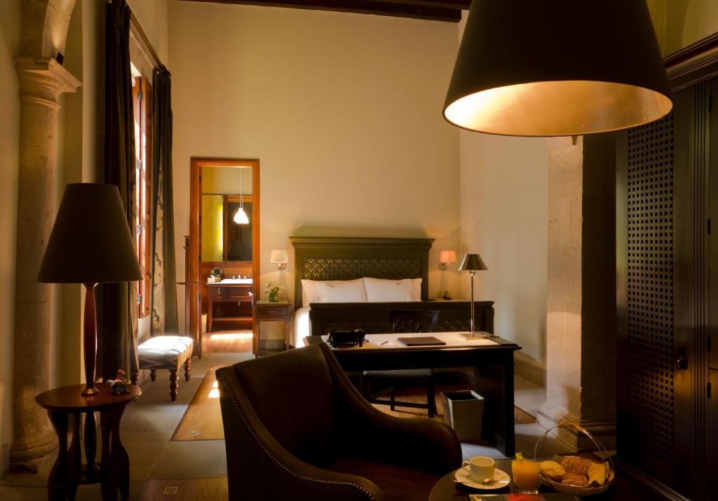 a bedroom with a bed and a desk in a room at Casa Grande Hotel Boutique in Morelia