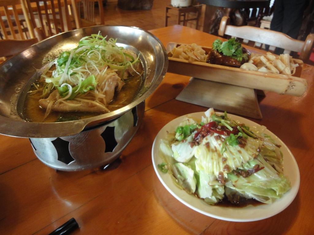 a table with a plate of food and a bowl of food at Kingtaiwan Hotel in Lugu Lake