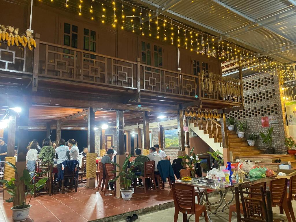 a group of people sitting at tables in a restaurant at Bac Son Homestay in Bắc Sơn