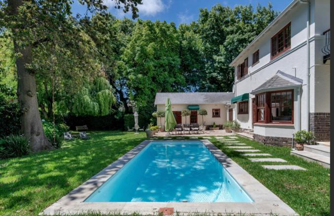 a swimming pool in the yard of a house at Park West Self-catering in Cape Town