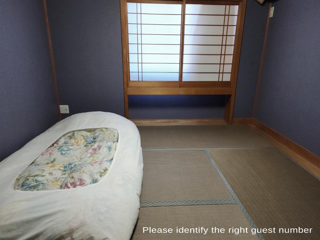 Postel nebo postele na pokoji v ubytování Narita Sando Guesthouse