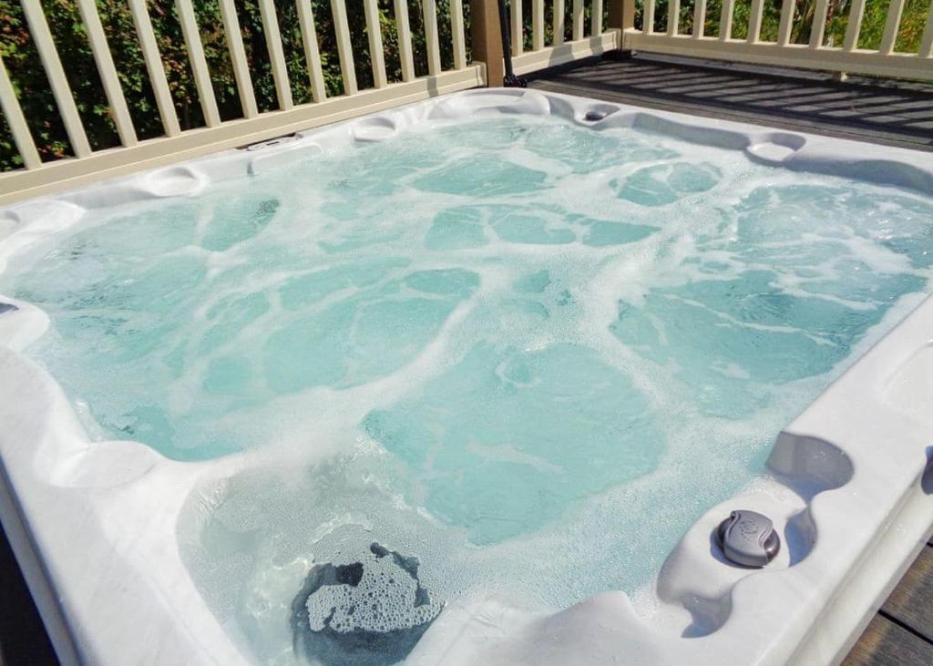 a jacuzzi tub filled with icy water at Otters Mead Boutique Lodges in Beetley