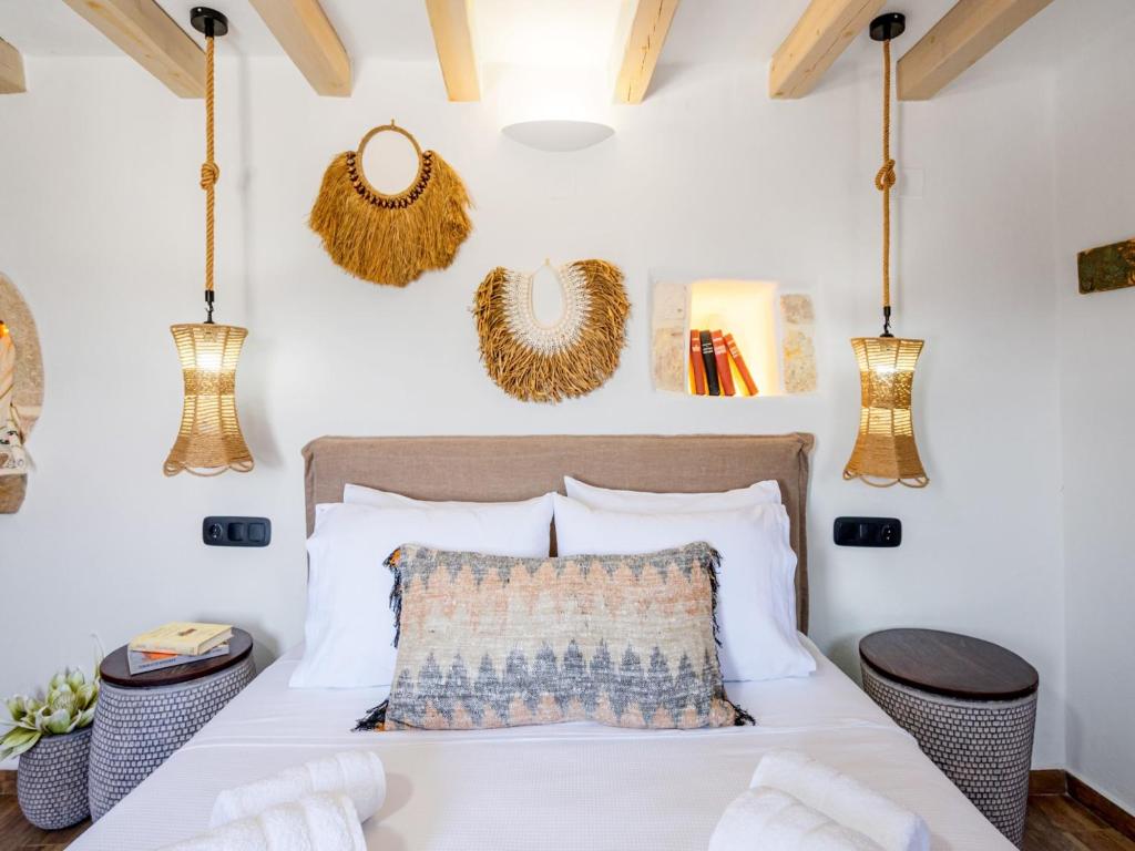 a bedroom with a white bed with a wooden headboard at Charming Cretan Villa near Sitia 