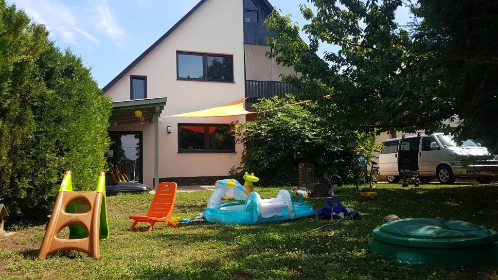 a yard with playground equipment in front of a house at Dream holiday at Balaton lake in Balatonlelle