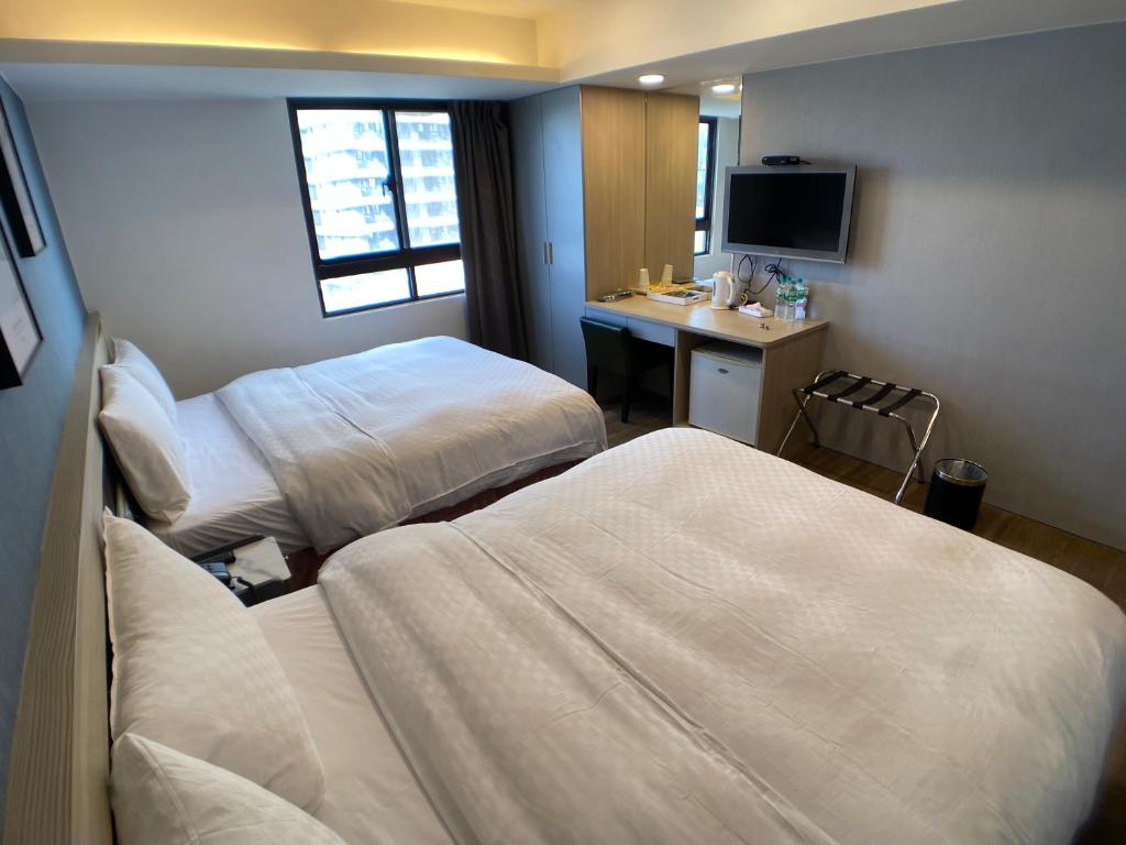 Postel nebo postele na pokoji v ubytování Bonjour Hotel
