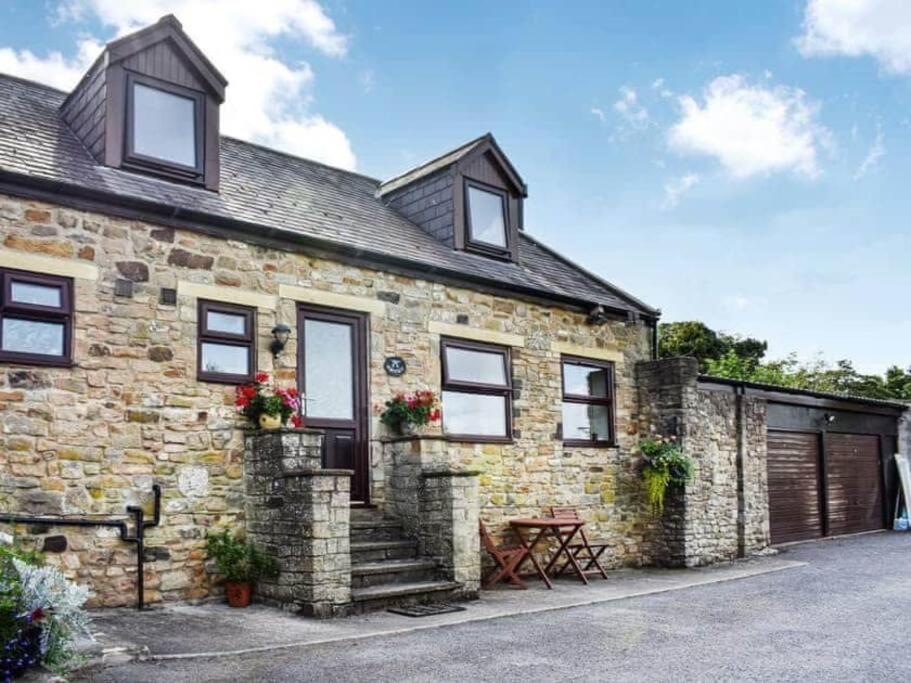 an exterior view of a stone house at The Smithy in Richmond