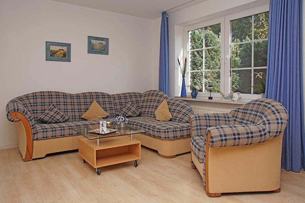 uma sala de estar com dois sofás e uma mesa em Haus Weisse Möwe Weisse Möwe 3 em Cuxhaven