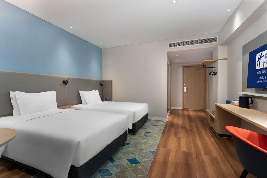 Postel nebo postele na pokoji v ubytování Holiday Inn Express Shunde Daliang by IHG