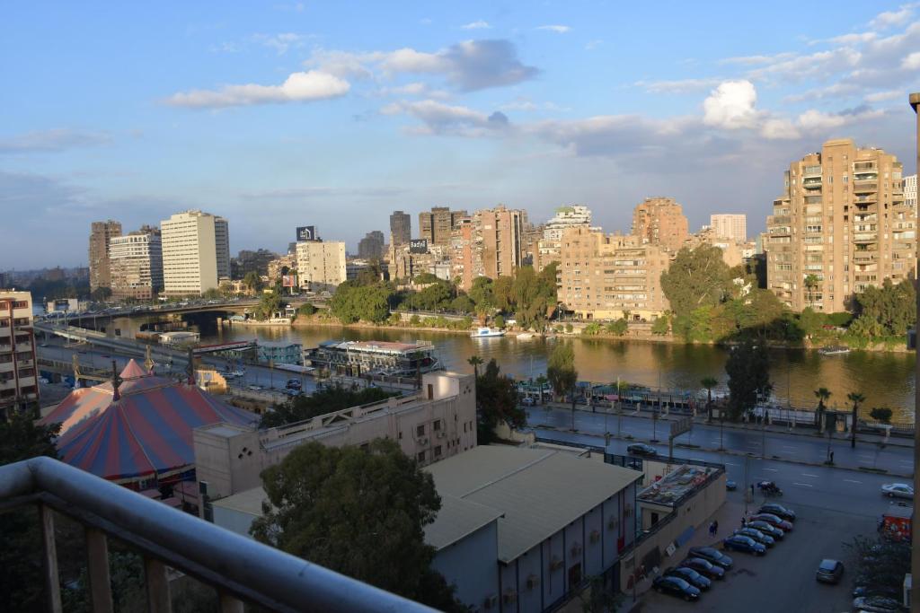 a view of a city with a river and buildings at Agouza NileView Apartment in Cairo