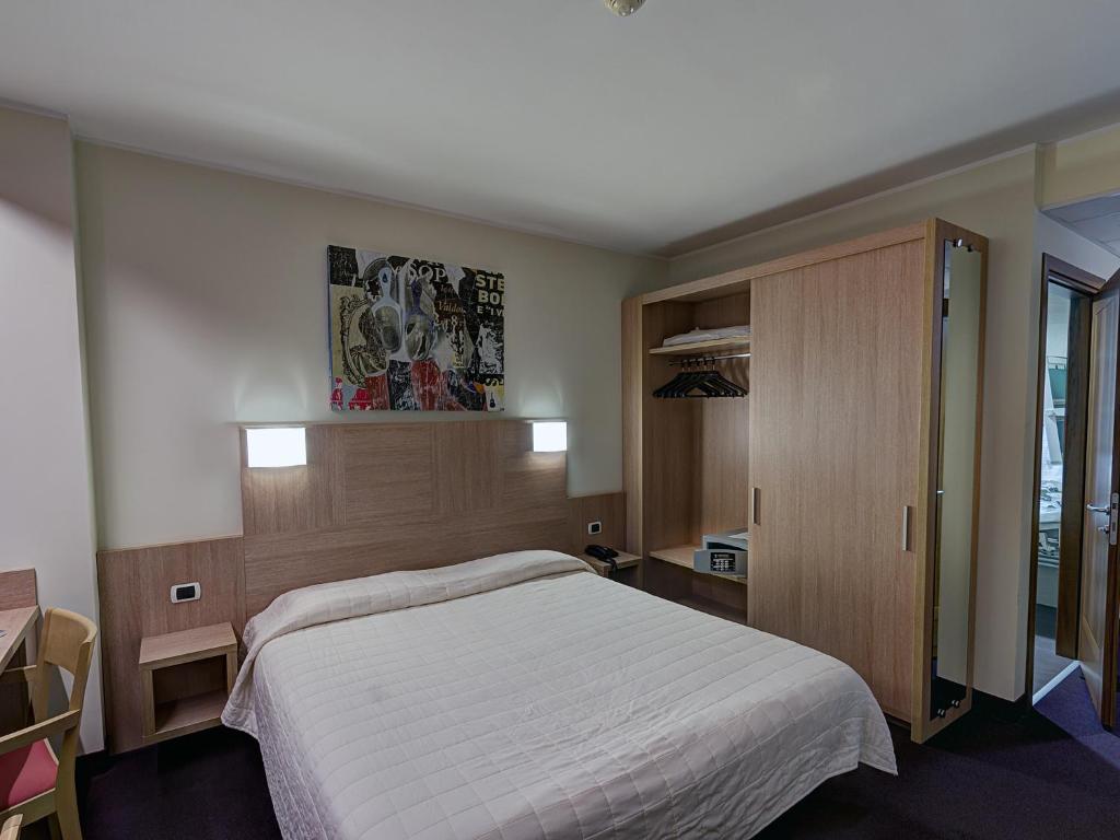 Postel nebo postele na pokoji v ubytování Hotel Capital