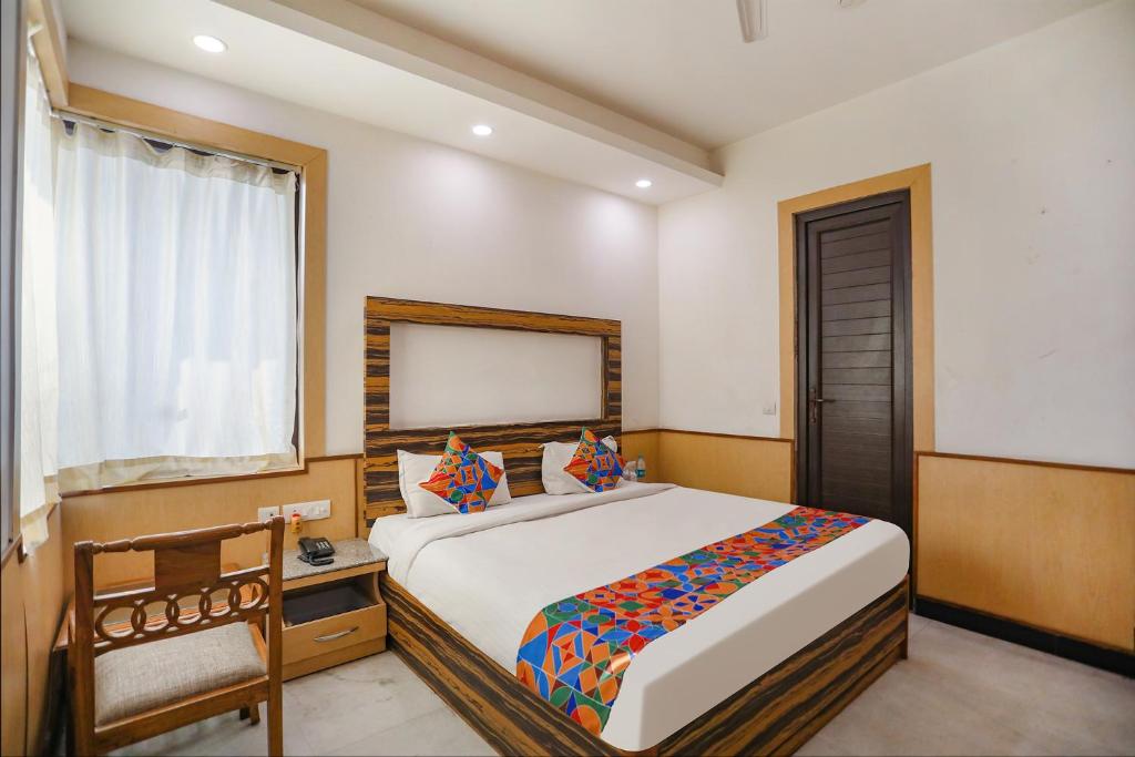 a bedroom with a large bed and a window at FabHotel The Horizon in Noida