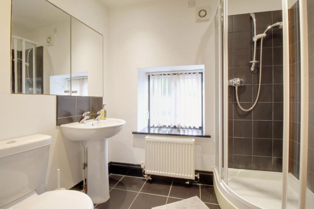 a bathroom with a sink toilet and a shower at Stable Cottage in Ross on Wye