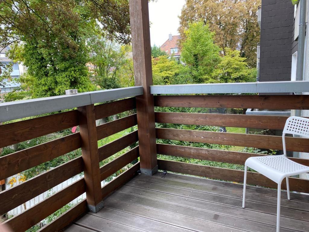 a deck with a white chair and a fence at ***Übernacht24*** Zentrale Wohnung in Gelsenkirchen in Gelsenkirchen