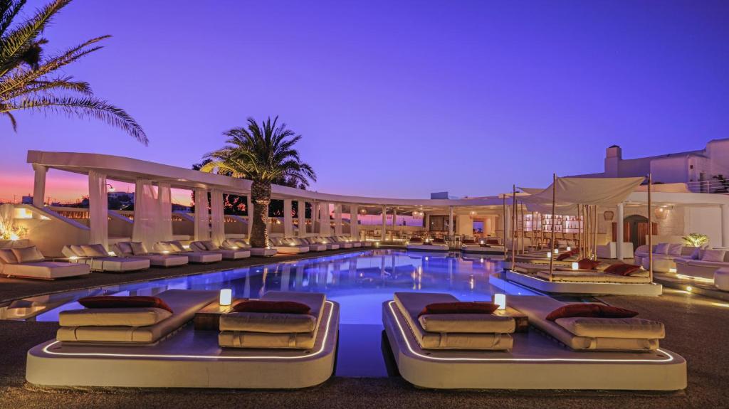 a hotel pool with lounge chairs and a resort at Andronikos Hotel in Mýkonos City