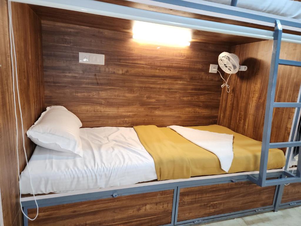 a bedroom with a bunk bed with a wooden wall at SAHIL AC DORMITORY in Navi Mumbai